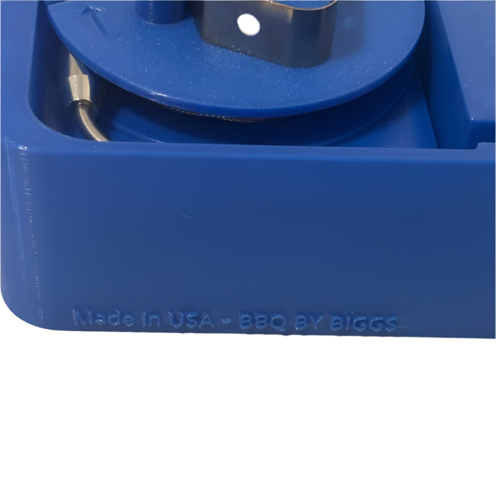 Blue mechanical component with 'Made in USA BBQ by Biggs' text on a beige background