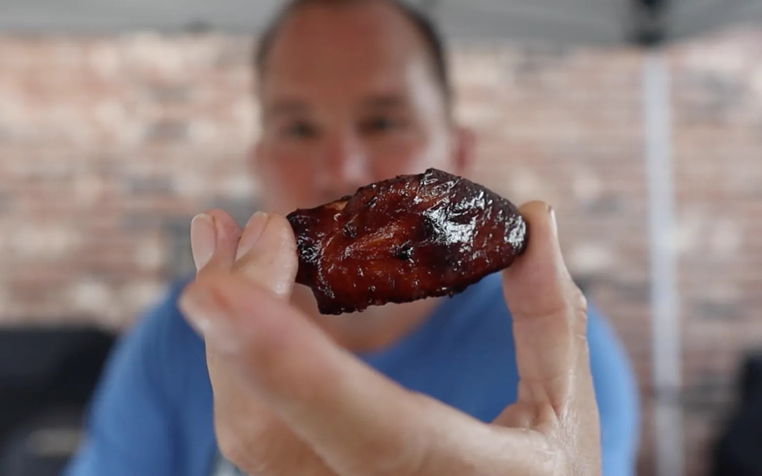 Mug shot sauced chicken wing