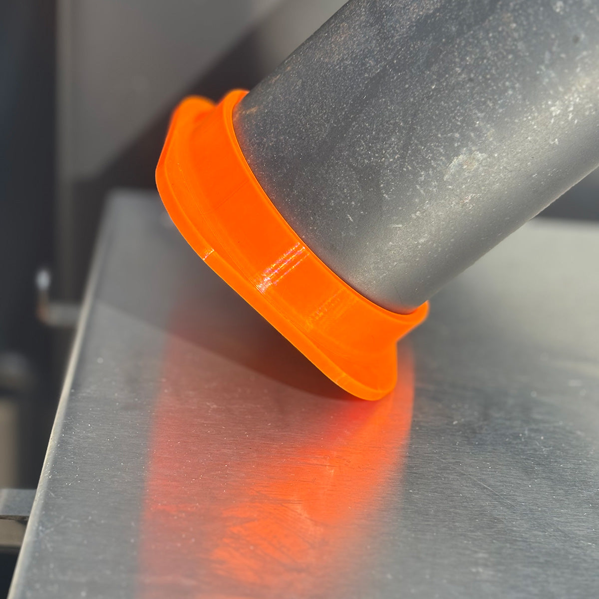 Orange Yoder ys640 smoke stack cap in the down position from the side